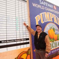 2011 winner Leonardo Urena points to his new state record on the results board