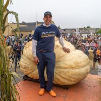 2022 Winner Travis Gienger and Winning Gourd with Crowd Behind